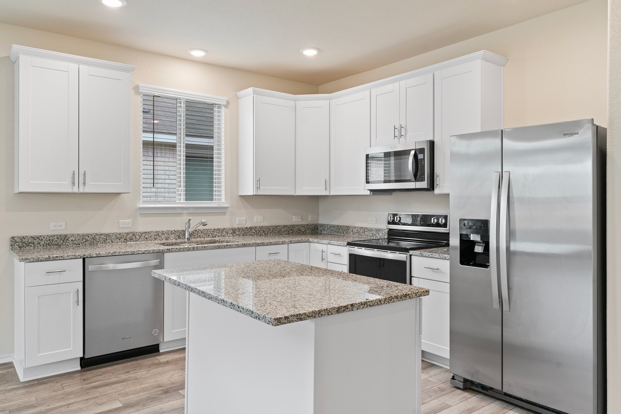 141 Onna Street Taylor, TX 76574 - Photo 9 of 26 a kitchen with a refrigerator sink and microwave