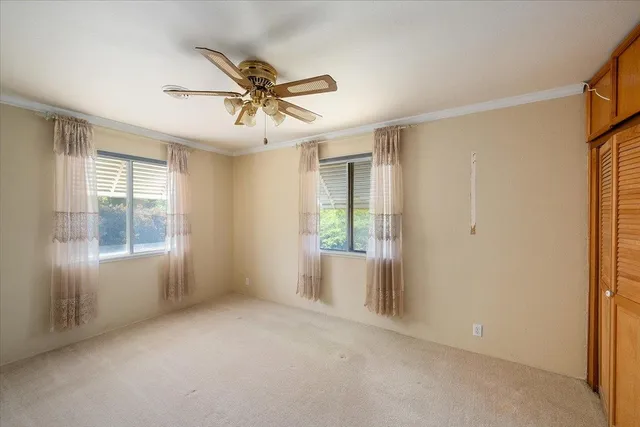a view of a livingroom with a ceiling fan and window