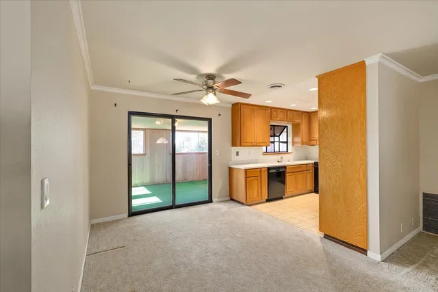 a large kitchen with a refrigerator a stove top oven a sink and dishwasher