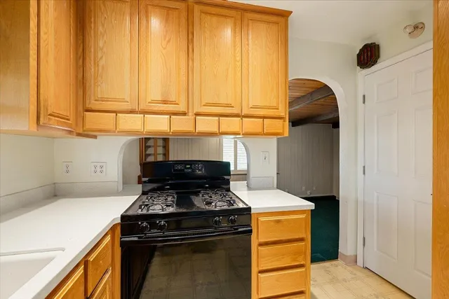 a kitchen with stainless steel appliances granite countertop a sink stove and cabinets