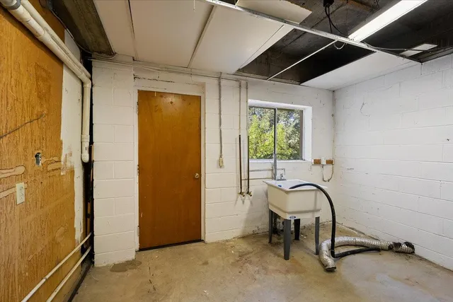 a view of yellow house with a big yard plants and large trees