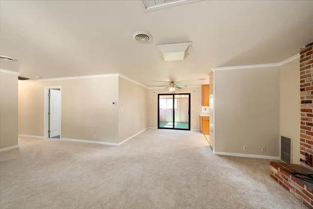 an empty room with furniture and a fireplace