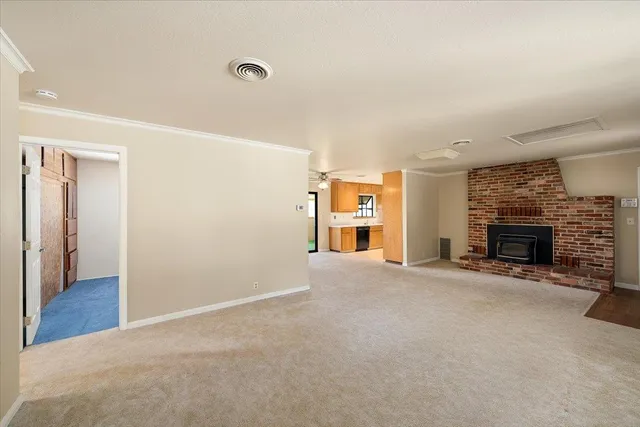 an empty room with furniture and a fireplace