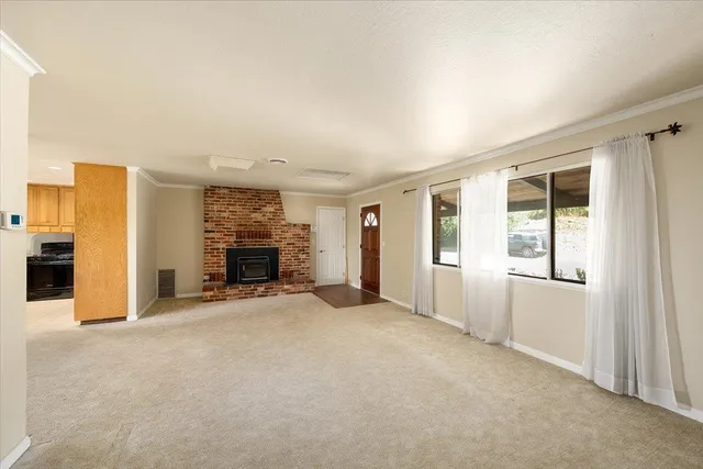 an empty room with windows and closet