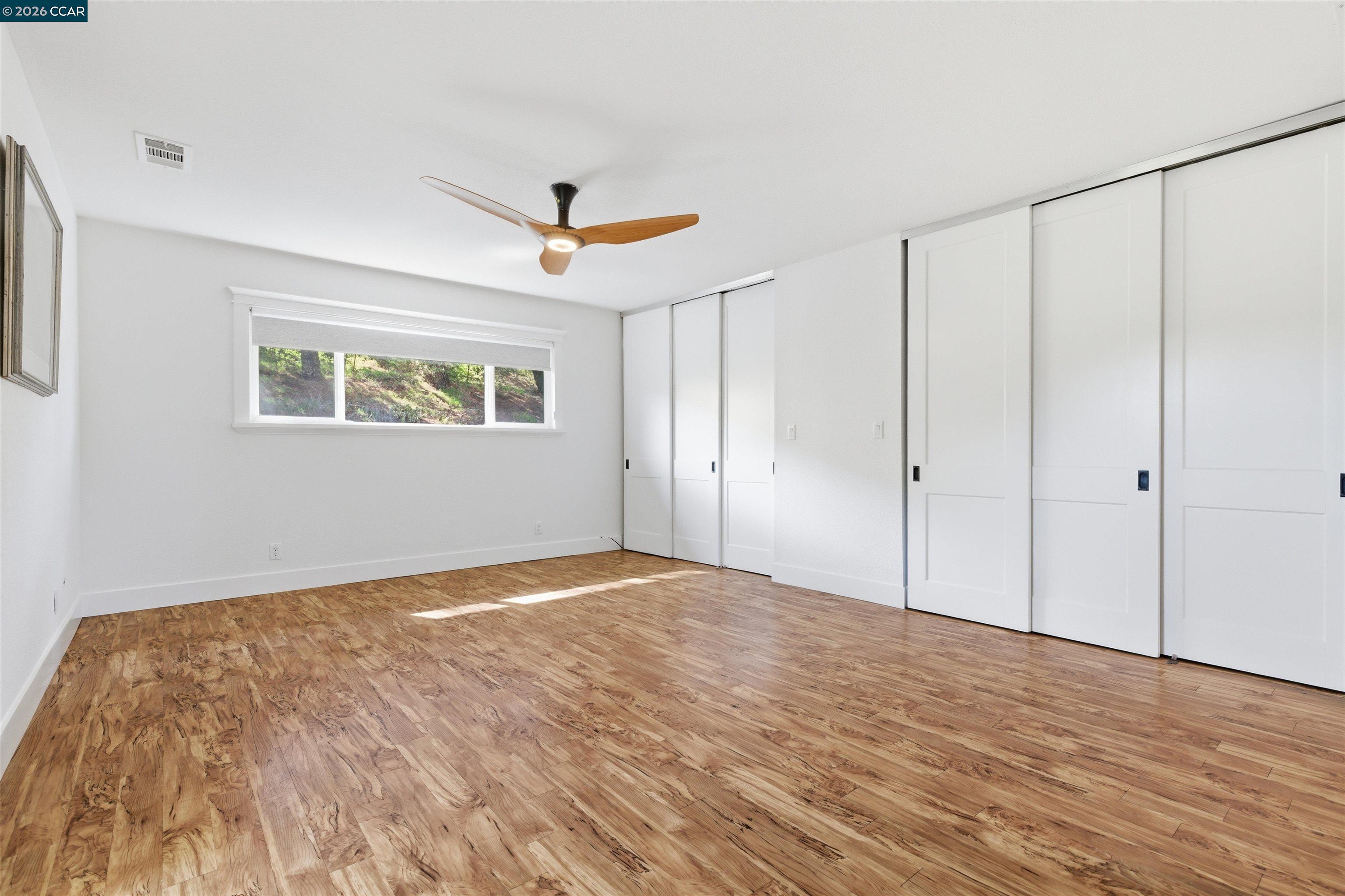 9530 Morgan Territory Road Livermore, CA 94551 - Photo 23 of 55 a view of empty room with wooden floor and fan