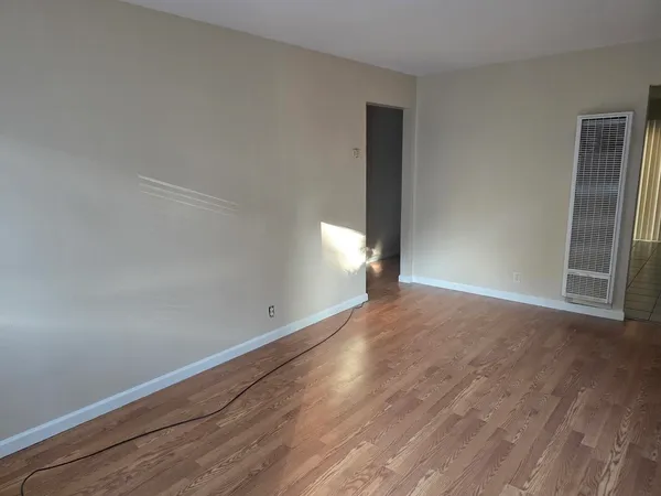 a kitchen with a sink a stove top oven and white cabinets