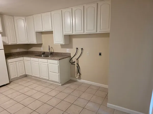 a view of a room with wooden floor and a ceiling fan
