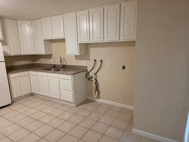 a view of a room with wooden floor and a ceiling fan