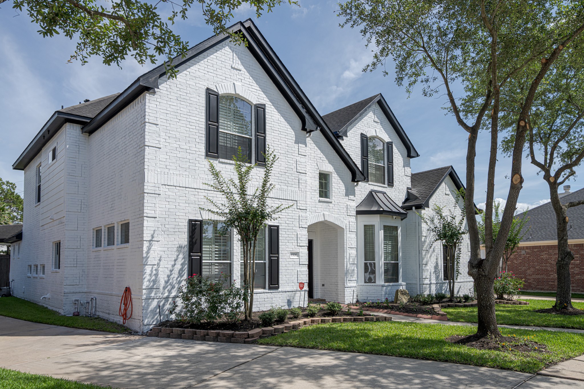 6506 Monte Bello Ridge Lane Houston, TX 77041 - Photo 30 of 39 This is a two-story, white brick home with black shutters