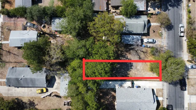 an aerial view of a houses with yard