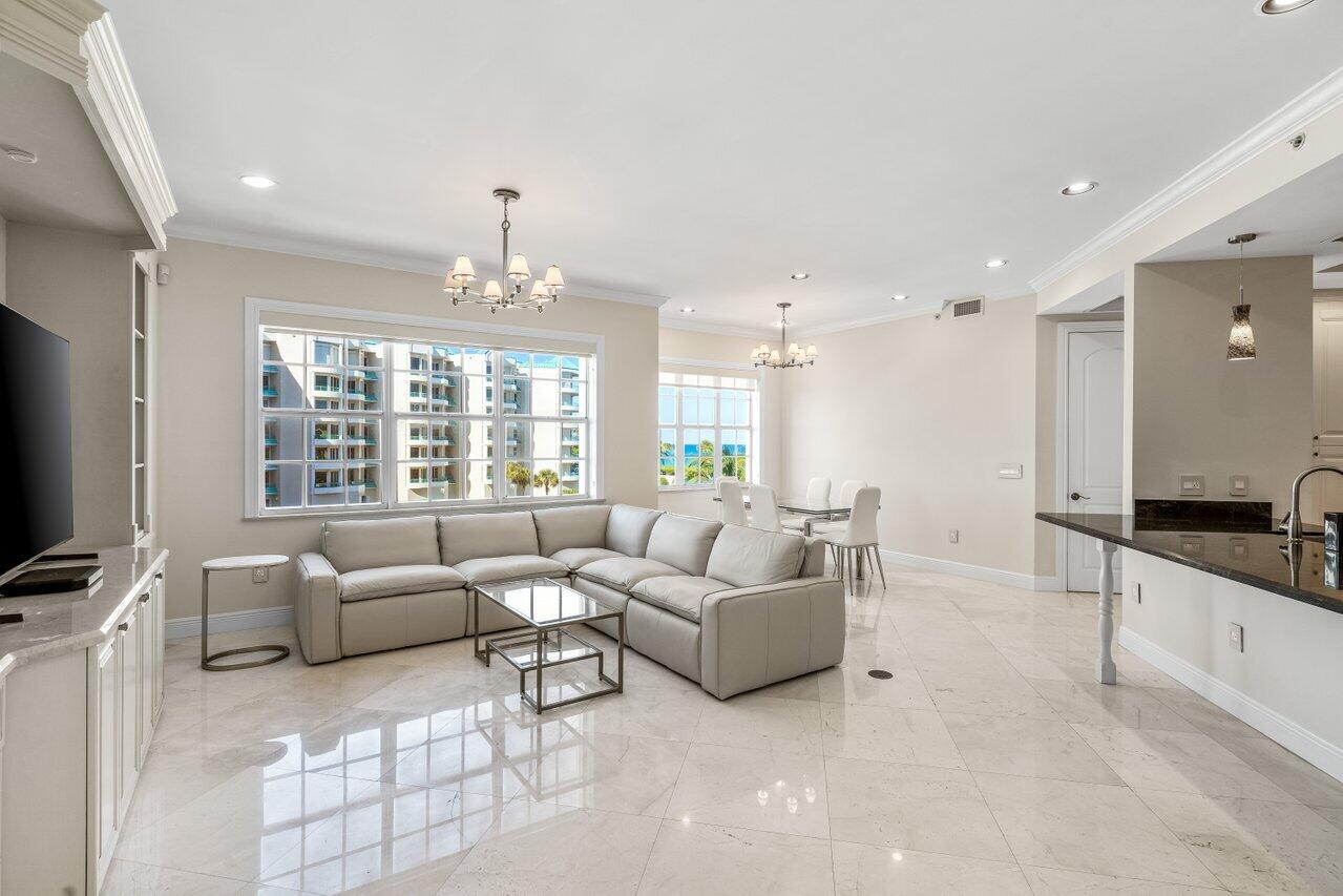 3000 Florida A1A, Unit 302 Daytona Beach, FL 32118 - Photo 16 of 48 a living room with furniture a flat screen tv and a large window