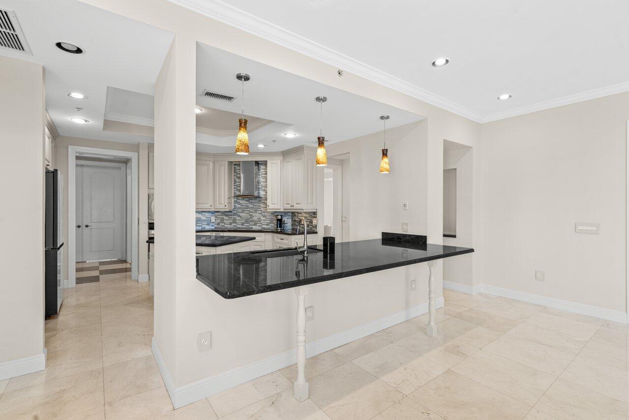 3000 Florida A1A, Unit 302 Daytona Beach, FL 32118 - Photo 18 of 48 a large kitchen with a sink and cabinets