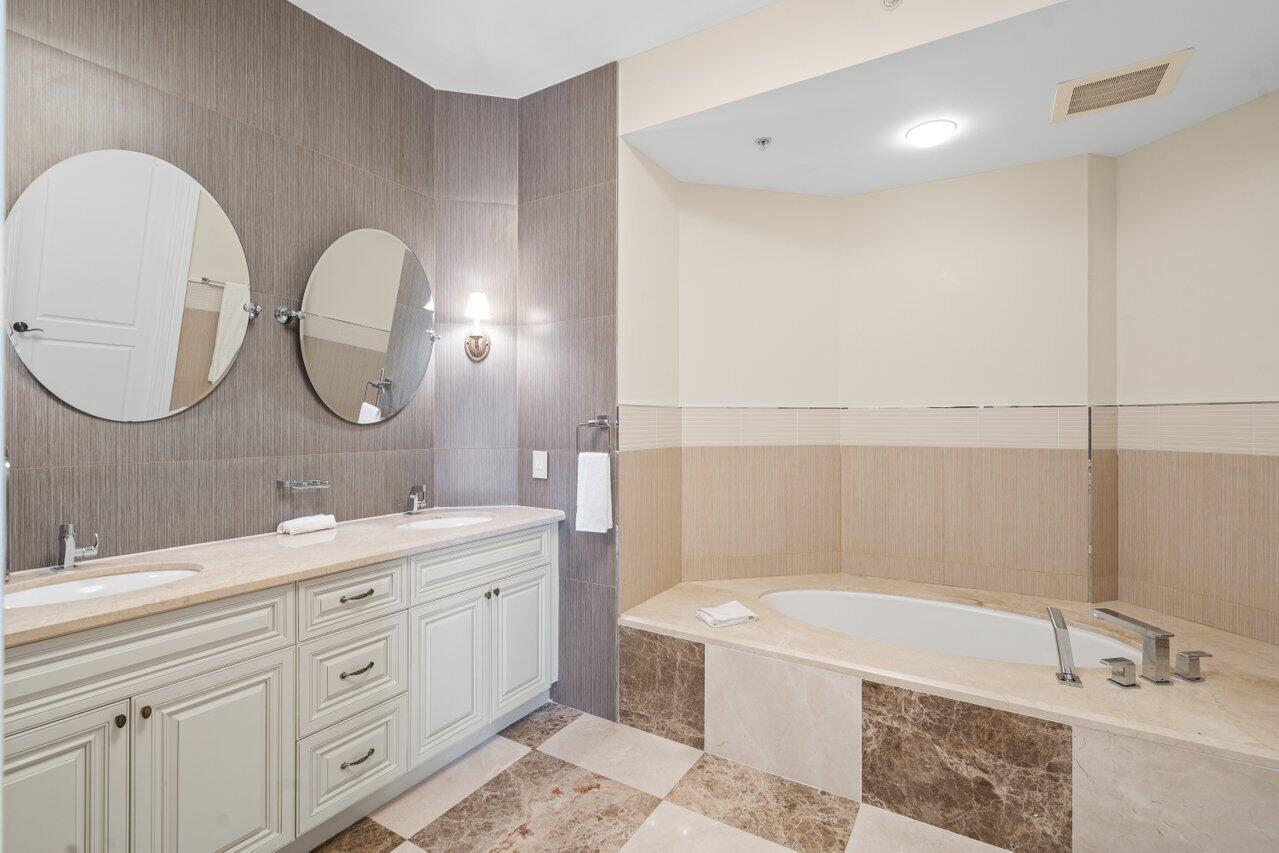 3000 Florida A1A, Unit 302 Daytona Beach, FL 32118 - Photo 19 of 48 a spacious bathroom with a double vanity sink mirror and bathtub
