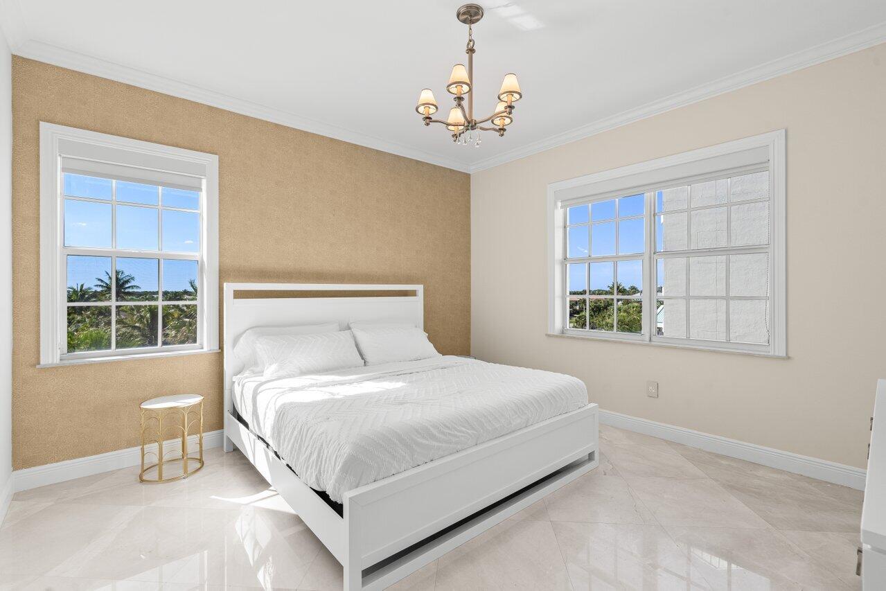 3000 Florida A1A, Unit 302 Daytona Beach, FL 32118 - Photo 25 of 48 a bedroom with a large bed and a window