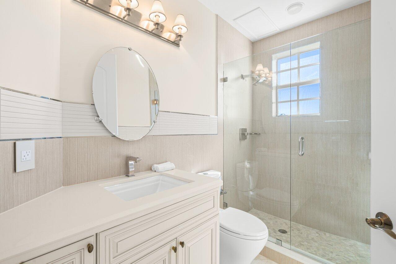 3000 Florida A1A, Unit 302 Daytona Beach, FL 32118 - Photo 26 of 48 a bathroom with a sink a toilet and a mirror