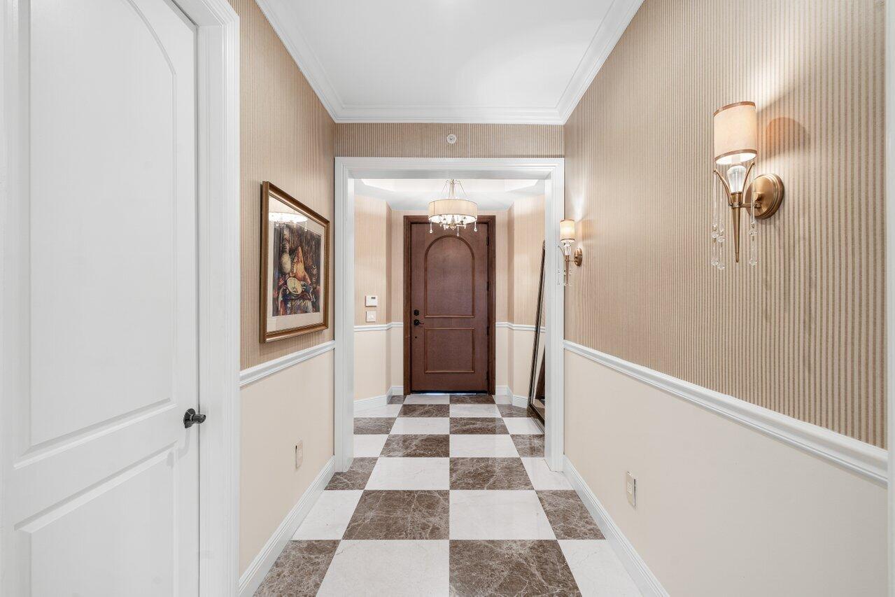 3000 Florida A1A, Unit 302 Daytona Beach, FL 32118 - Photo 3 of 48 a view of a hallway with a black and white checkered floor