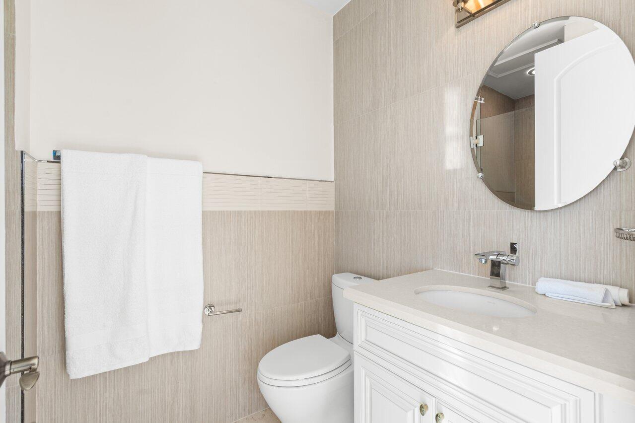 3000 Florida A1A, Unit 302 Daytona Beach, FL 32118 - Photo 31 of 48 a bathroom with a sink and a mirror