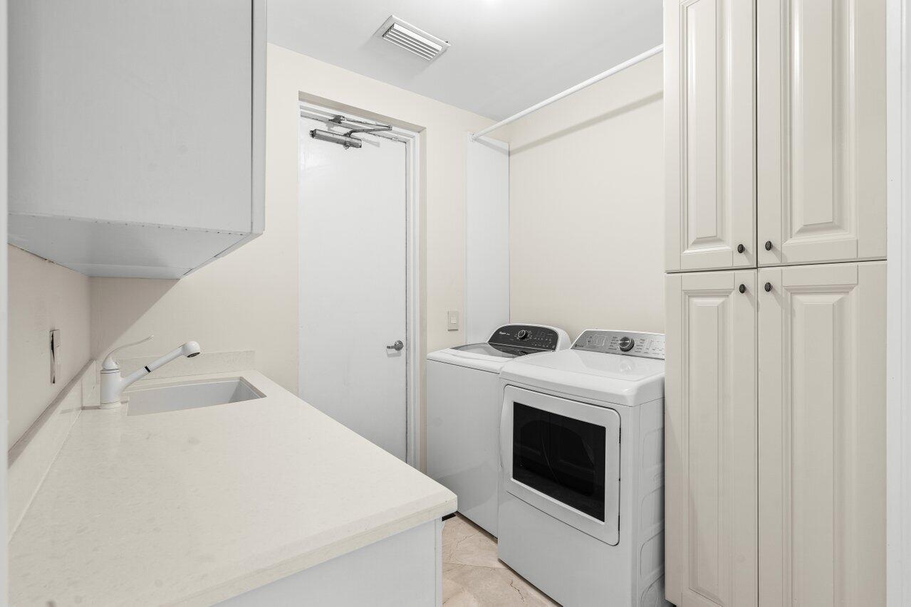 3000 Florida A1A, Unit 302 Daytona Beach, FL 32118 - Photo 33 of 48 a utility room with dryer and washer