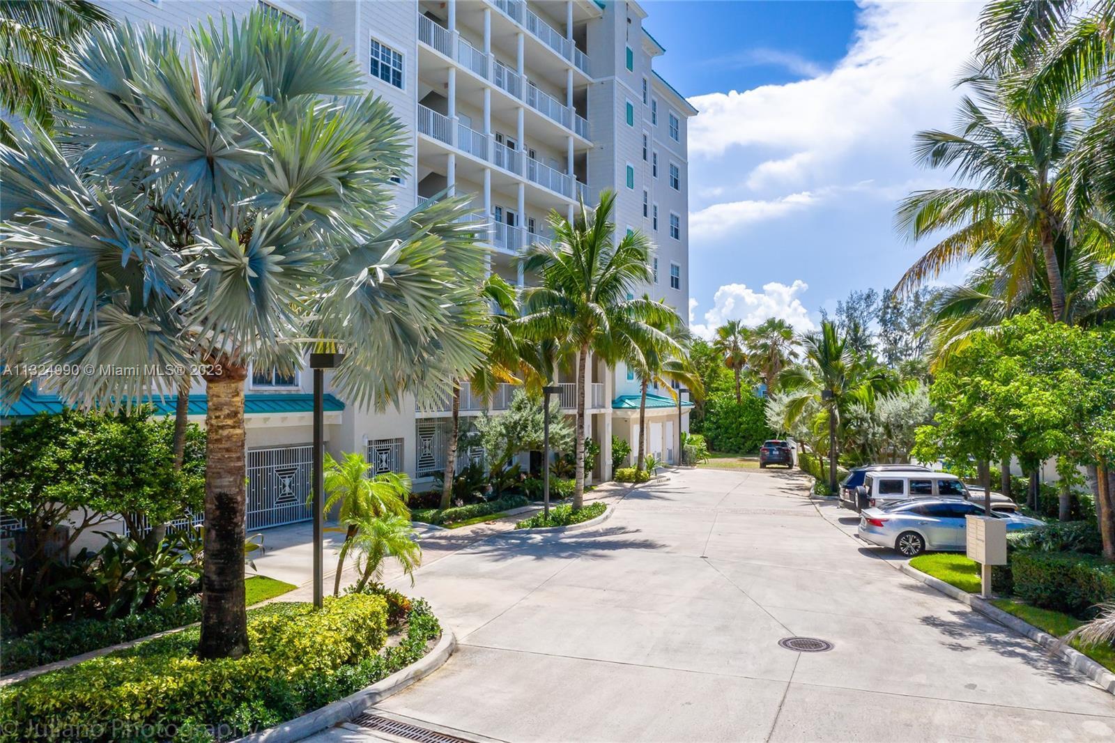 3000 Florida A1A, Unit 302 Daytona Beach, FL 32118 - Photo 41 of 48 a row of palm trees sitting in front of a building