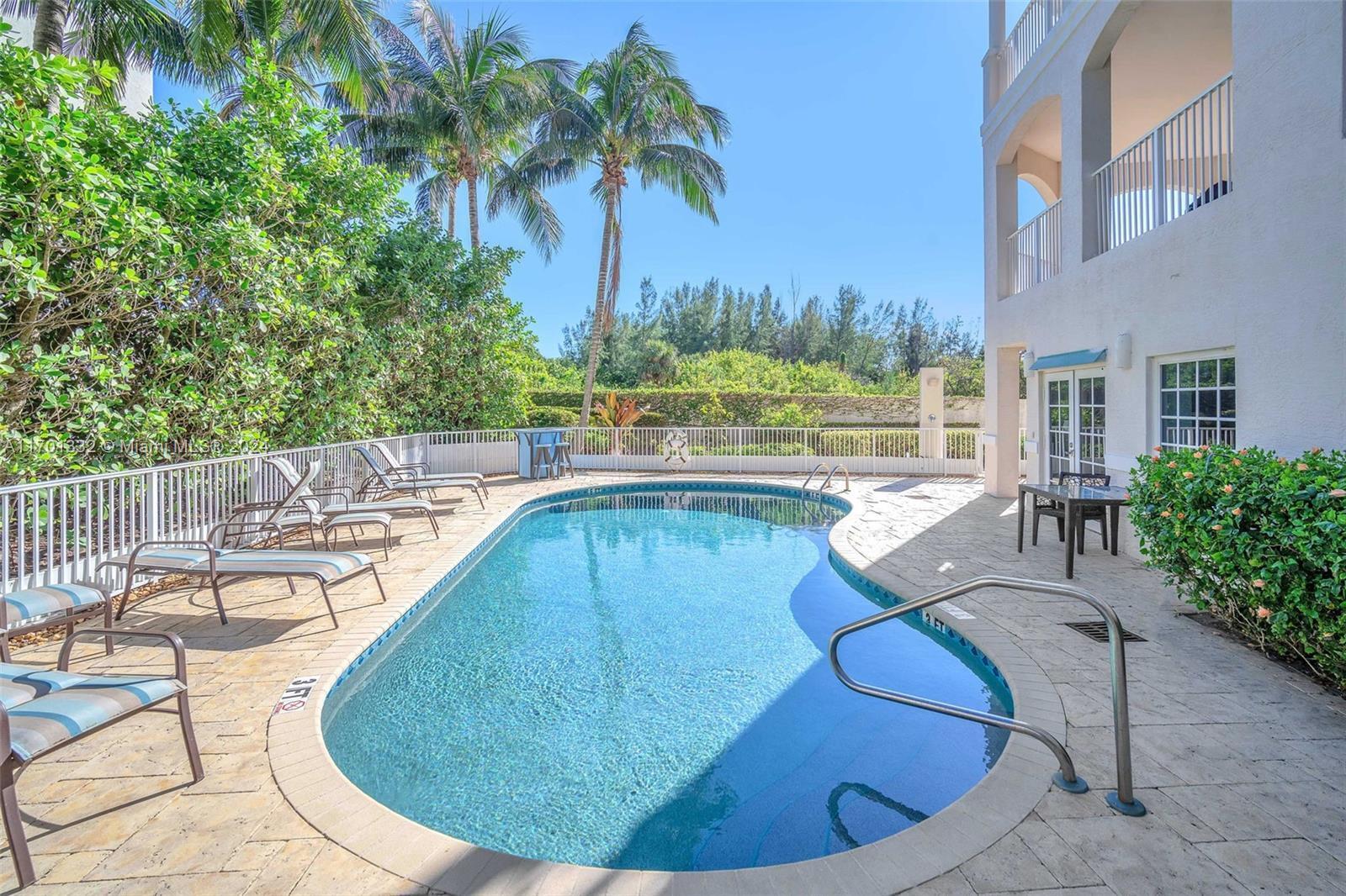 3000 Florida A1A, Unit 302 Daytona Beach, FL 32118 - Photo 43 of 48 a view of a swimming pool with lounge chair