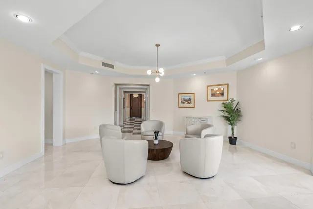 a living room with furniture and a chandelier