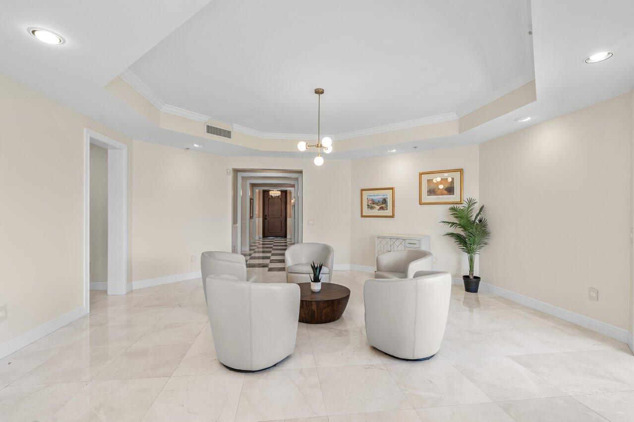 3000 Florida A1A, Unit 302 Daytona Beach, FL 32118 - Photo 5 of 48 a living room with furniture and a chandelier