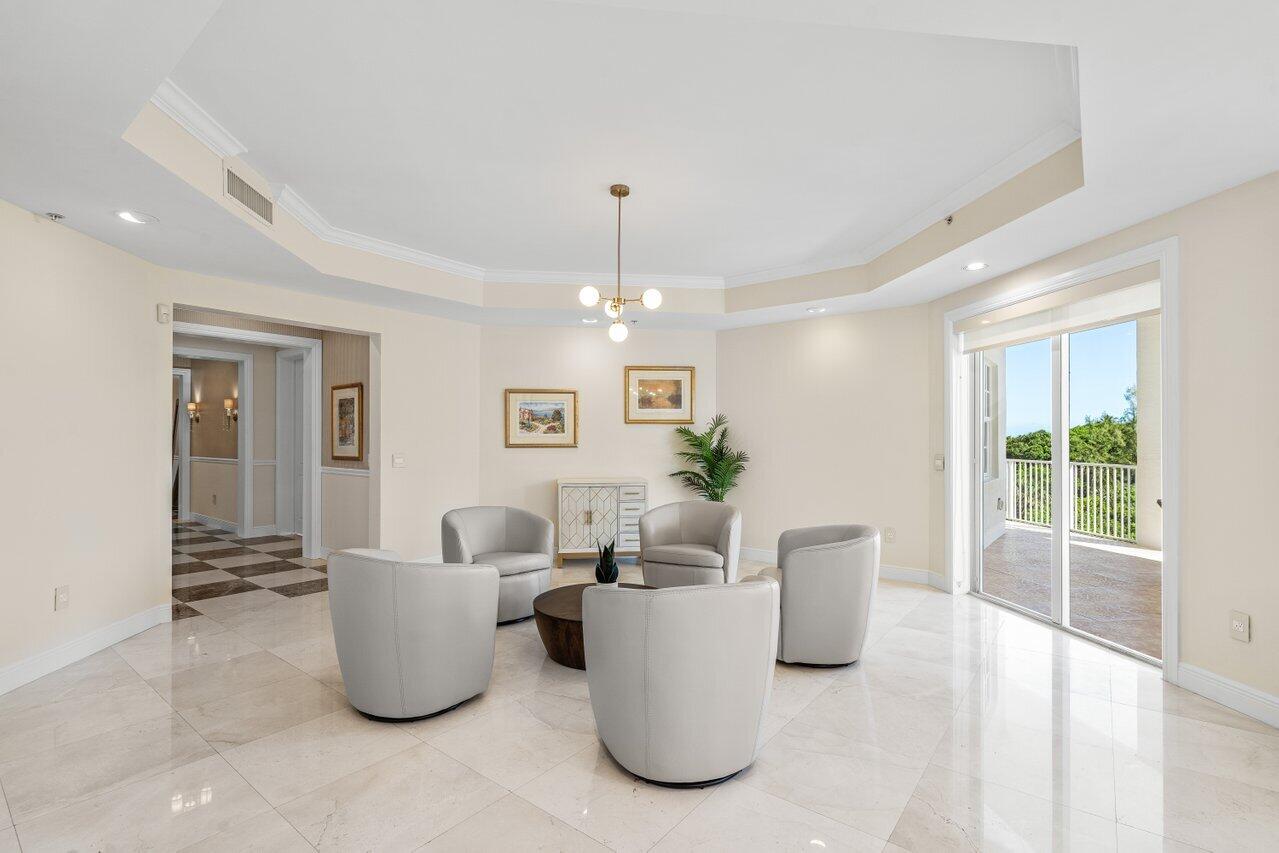 3000 Florida A1A, Unit 302 Daytona Beach, FL 32118 - Photo 6 of 48 a living room with furniture a large window and potted plants