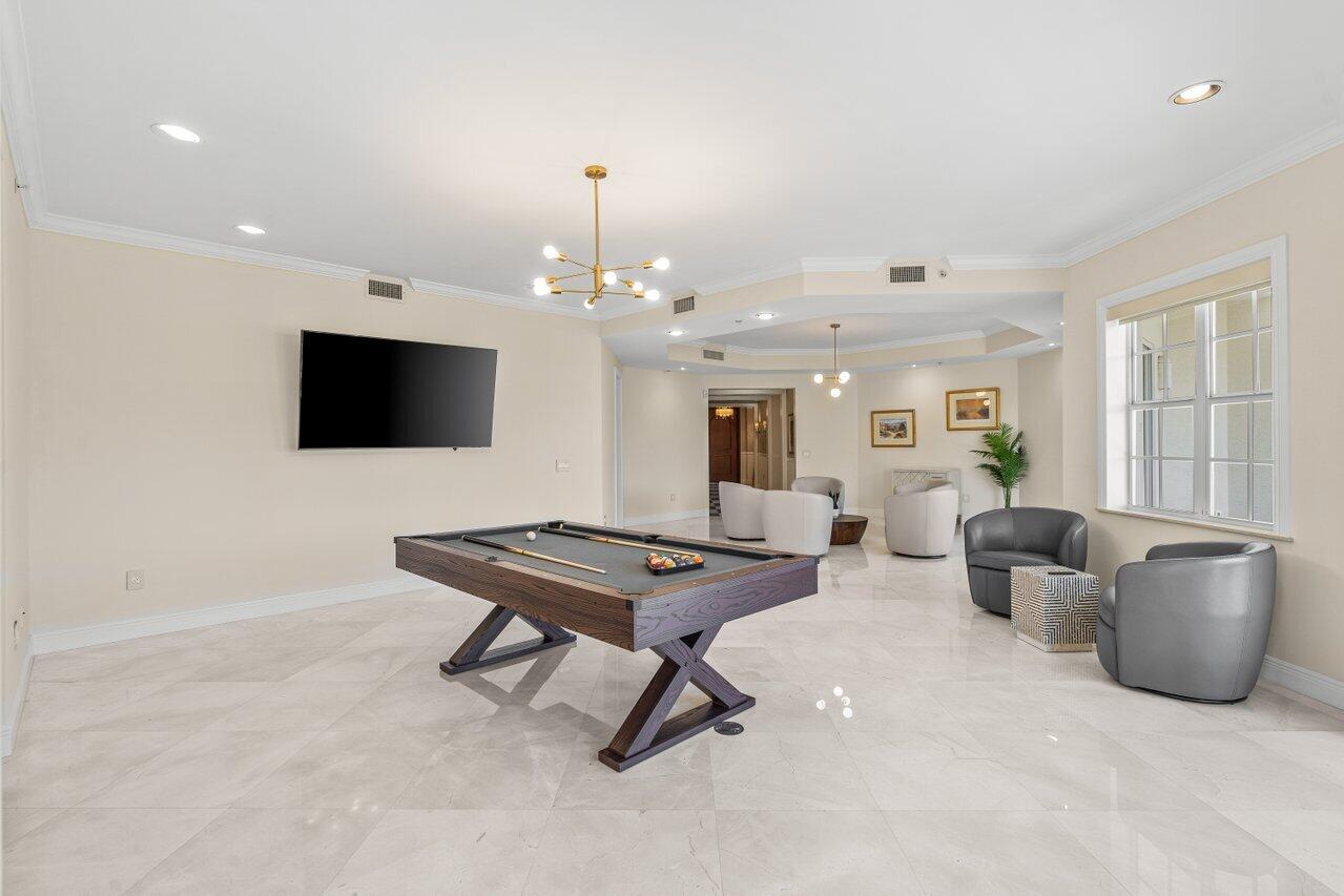 3000 Florida A1A, Unit 302 Daytona Beach, FL 32118 - Photo 7 of 48 a living room with furniture and a flat screen tv