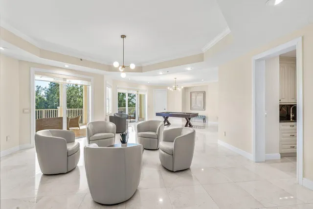 a living room with furniture and a chandelier