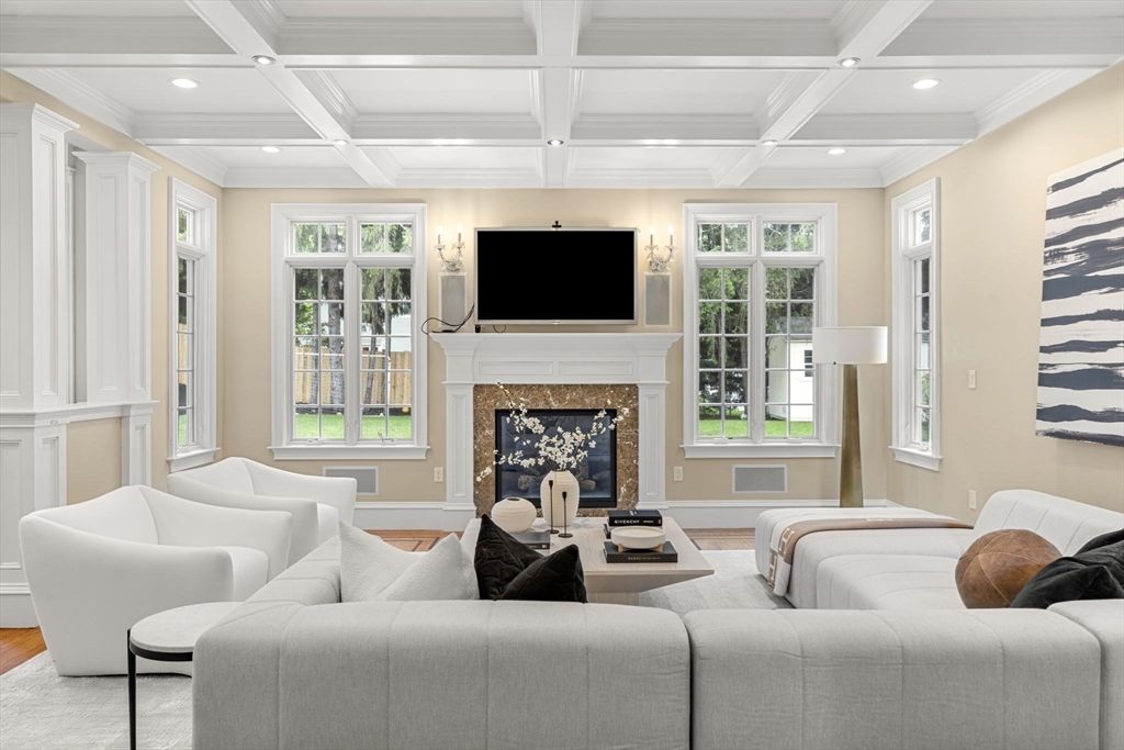 22 Scotney Road Newton, MA 02467 - Photo 15 of 42 a living room with furniture a fireplace and a flat screen tv