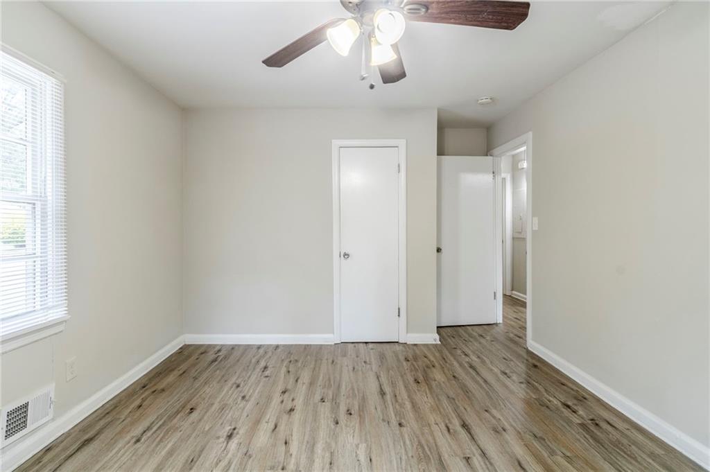 6281 Denny Lane Southwest Mableton, GA 30126 - Photo 17 of 27 an empty room with wooden floor and windows
