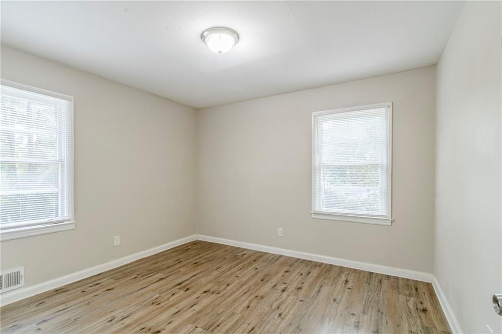 6281 Denny Lane Southwest Mableton, GA 30126 - Photo 18 of 27 an empty room with wooden floor and windows