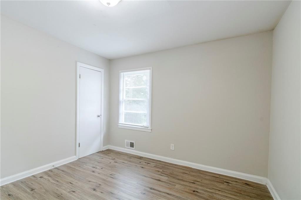 6281 Denny Lane Southwest Mableton, GA 30126 - Photo 20 of 27 a view of an empty room with wooden floor and a window