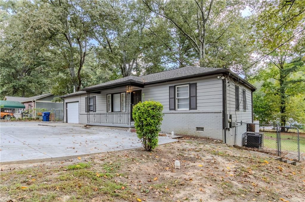 6281 Denny Lane Southwest Mableton, GA 30126 - Photo 2 of 27 a view of a house with a yard and large tree