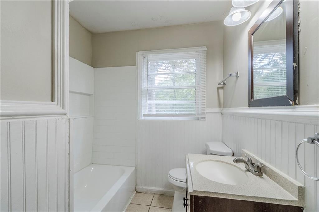 6281 Denny Lane Southwest Mableton, GA 30126 - Photo 21 of 27 a bathroom with a sink toilet a tub and shower