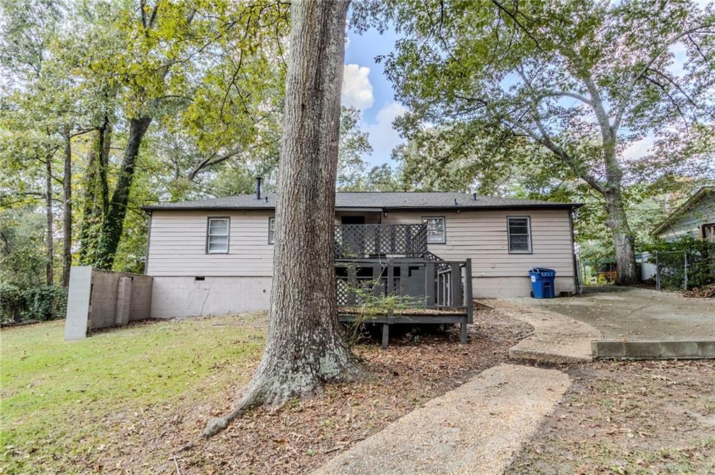 6281 Denny Lane Southwest Mableton, GA 30126 - Photo 22 of 27 a view of a house with backyard and a tree