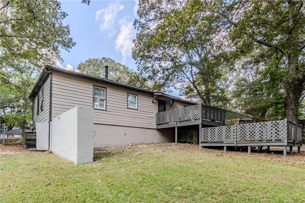 6281 Denny Lane Southwest Mableton, GA 30126 - Photo 23 of 27 a view of a house with a yard and wooden fence