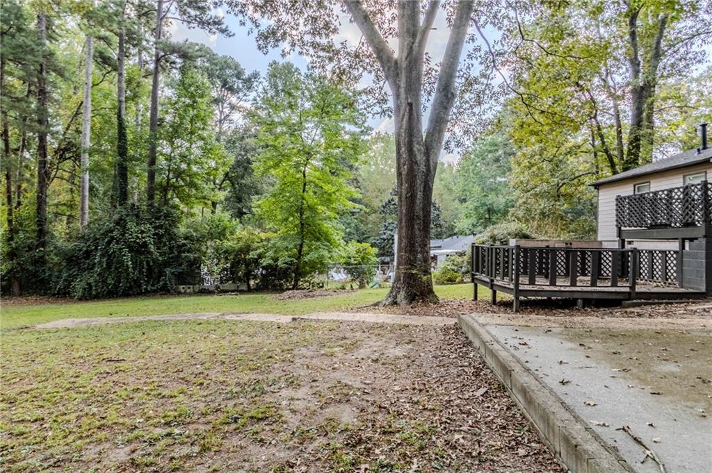 6281 Denny Lane Southwest Mableton, GA 30126 - Photo 25 of 27 a view of a house with backyard and trees