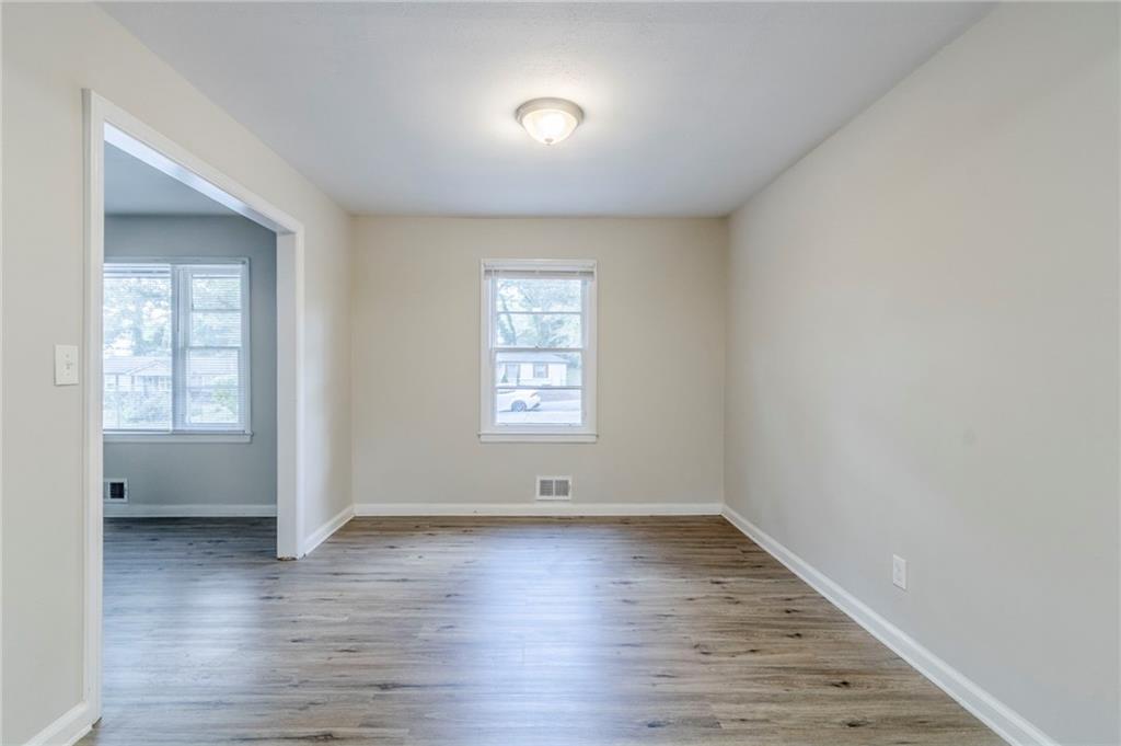 6281 Denny Lane Southwest Mableton, GA 30126 - Photo 7 of 27 an empty room with wooden floor and windows