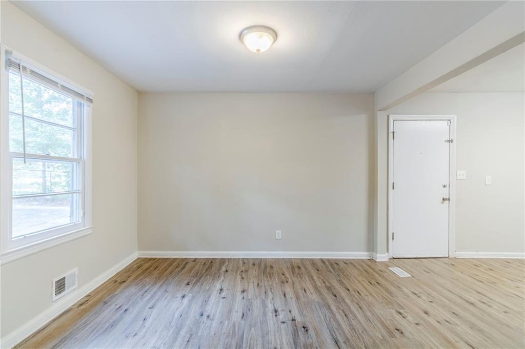 6281 Denny Lane Southwest Mableton, GA 30126 - Photo 10 of 27 an empty room with wooden floor and windows