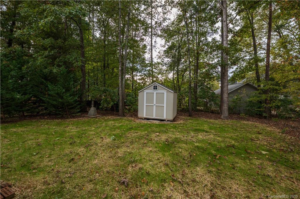 7734 Red Robin Trail Denver, NC 28037 - Photo 2 of 15 a backyard of a house with trees and entertaining space