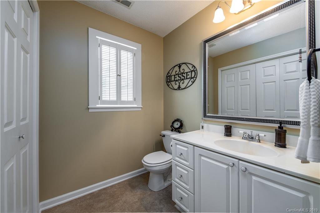 7734 Red Robin Trail Denver, NC 28037 - Photo 14 of 15 a bathroom with a toilet a sink and mirror