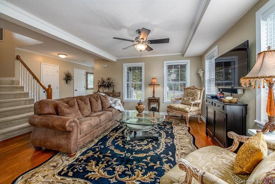 7734 Red Robin Trail Denver, NC 28037 - Photo 4 of 15 a living room with furniture ceiling fan and a rug