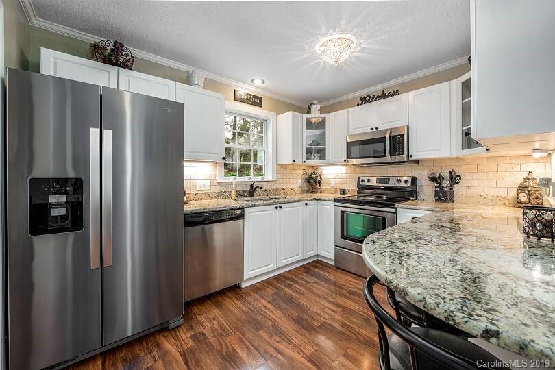 7734 Red Robin Trail Denver, NC 28037 - Photo 5 of 15 a kitchen with stainless steel appliances granite countertop a refrigerator stove and sink
