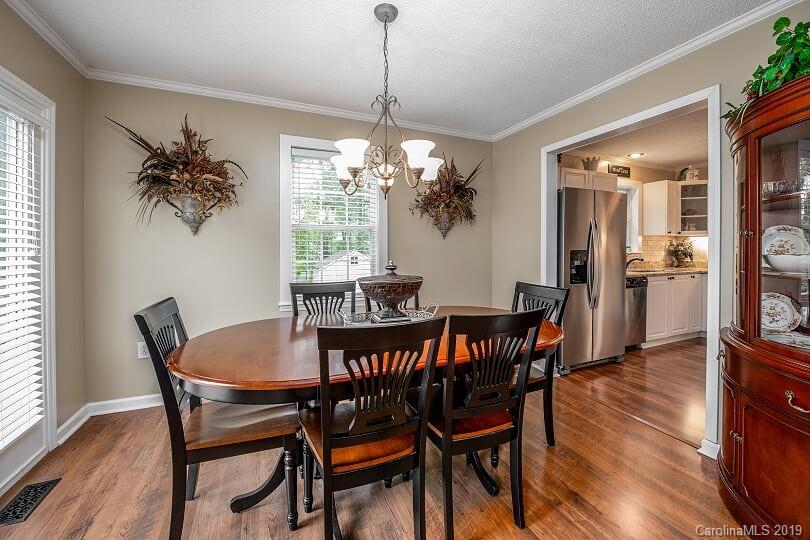 7734 Red Robin Trail Denver, NC 28037 - Photo 6 of 15 a view of a dining room with furniture wooden floor and chandelier