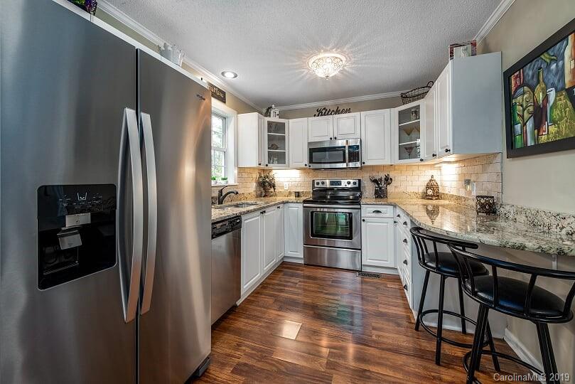 7734 Red Robin Trail Denver, NC 28037 - Photo 7 of 15 a kitchen with stainless steel appliances granite countertop a refrigerator stove microwave and sink