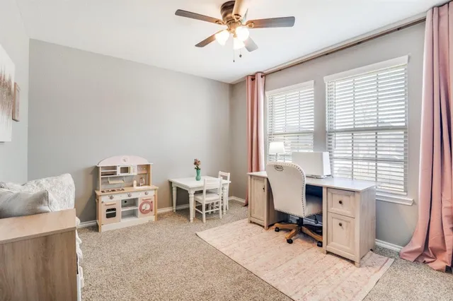 a view of a livingroom with workspace and a window