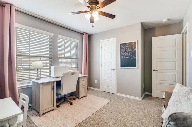 a view of a livingroom with workspace and a window
