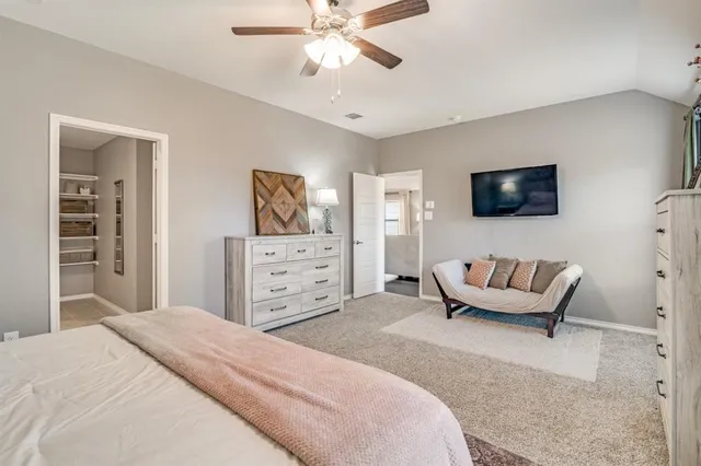 a bedroom with a bed and a couch