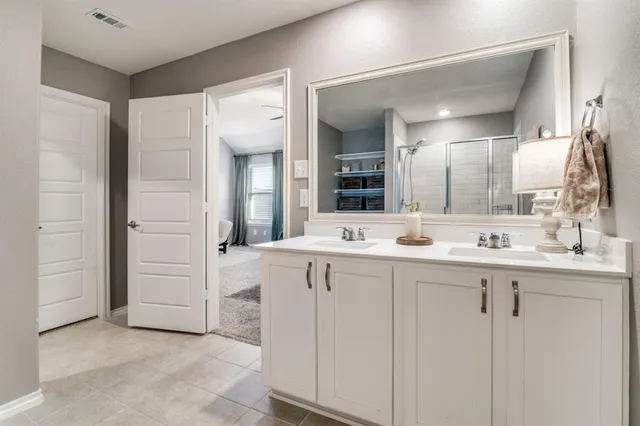 a bathroom with a double vanity sink and a mirror